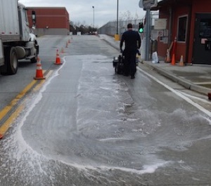 cleaning hydraulic oil from pavement with HC-2000 and powerbrooms